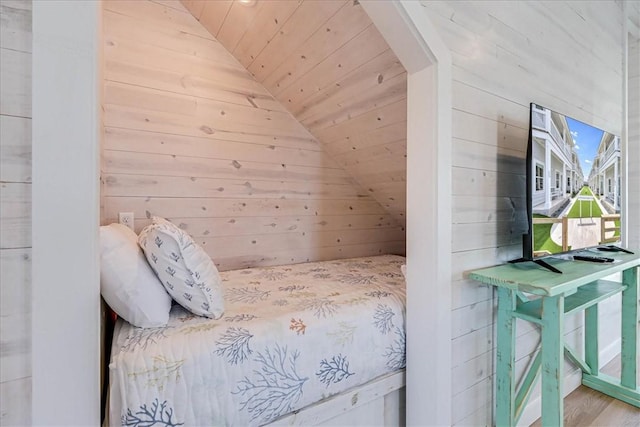 unfurnished bedroom featuring wooden walls, wood ceiling, and vaulted ceiling