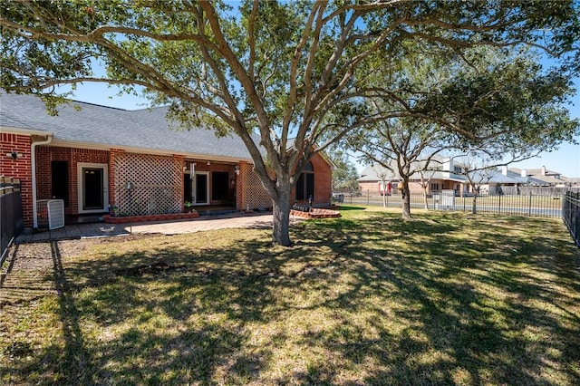 view of yard featuring fence, a patio, and central AC unit