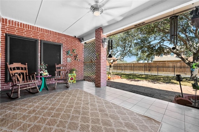 view of patio with fence and a ceiling fan