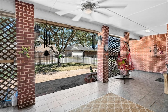 view of patio with a ceiling fan and fence