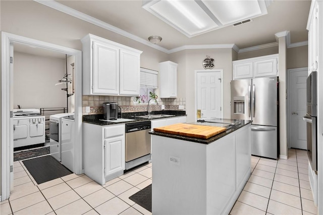 4302 Pontchartrain Dr, Corpus Christi, TX 78413 - kitchen with appliances with stainless steel finishes, white cabinetry, a kitchen island, wooden counters, and backsplash
