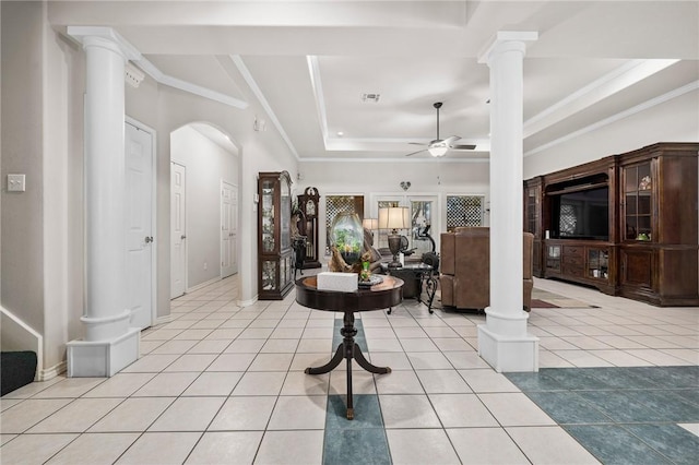 foyer with ornate columns, light tile patterned floors, ornamental molding, and a raised ceiling