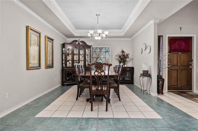 tiled dining space featuring crown molding, a tray ceiling, baseboards, and an inviting chandelier