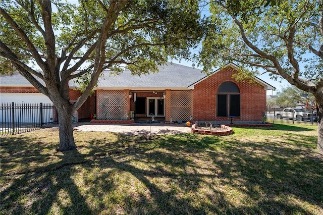 back of property with a patio, an attached garage, brick siding, fence, and a lawn