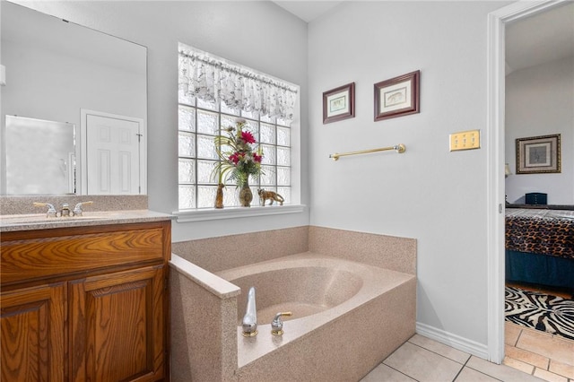 ensuite bathroom with a garden tub, vanity, ensuite bathroom, and tile patterned floors