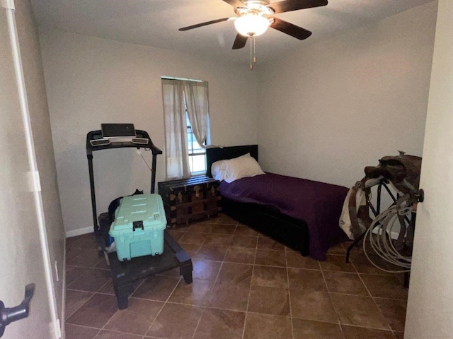 bedroom with ceiling fan and dark tile patterned flooring