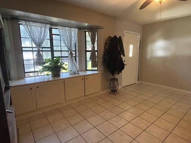 entryway featuring light tile patterned floors and ceiling fan