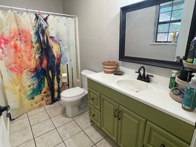 bathroom with toilet, walk in shower, vanity, and tile patterned floors