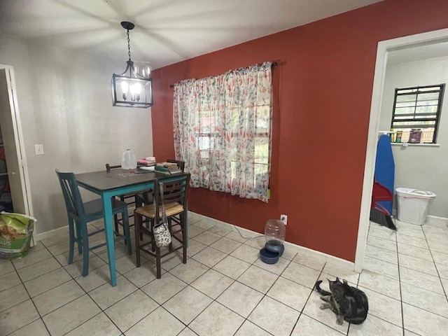 dining room featuring an inviting chandelier and tile patterned flooring