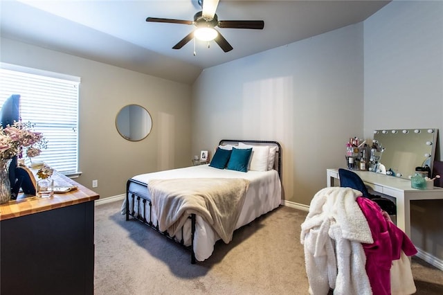 carpeted bedroom featuring ceiling fan and vaulted ceiling