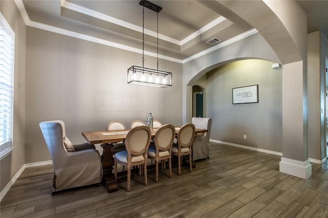 dining room featuring crown molding and a tray ceiling