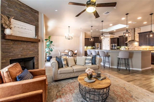 living room with ceiling fan, dark wood-type flooring, and a fireplace