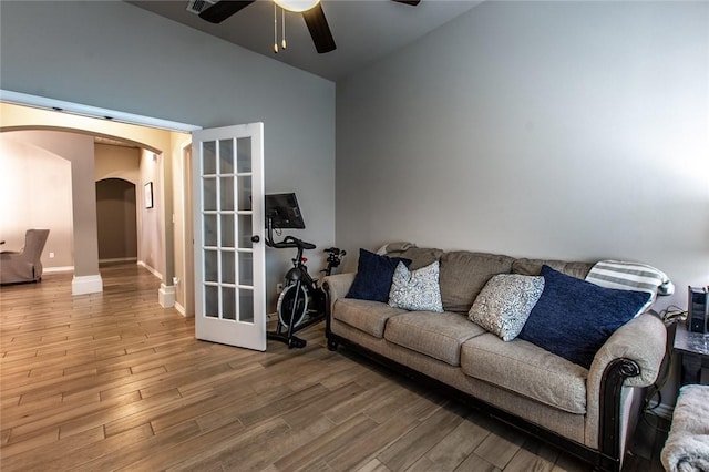 living room featuring hardwood / wood-style flooring, ceiling fan, and lofted ceiling