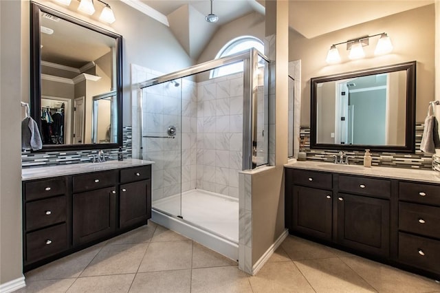 bathroom featuring vanity, ornamental molding, backsplash, and walk in shower