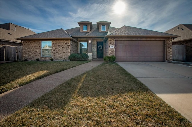 view of front facade featuring a garage and a front lawn