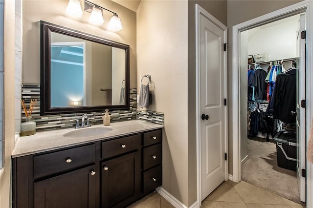 bathroom featuring tasteful backsplash, vanity, and tile patterned floors