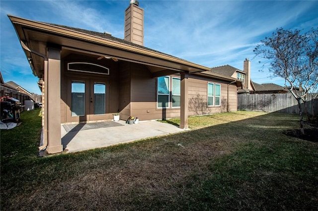 back of property featuring a yard and a patio area