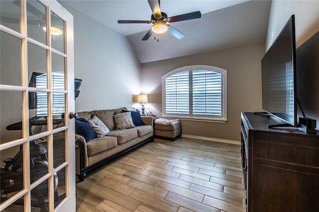 living room featuring french doors, ceiling fan, and vaulted ceiling