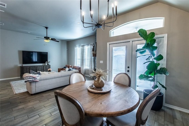 dining room featuring hardwood / wood-style flooring and ceiling fan with notable chandelier