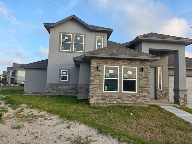 714 Mereet Dr, Corpus Christi, TX 78418 - view of front facade with a shingled roof, a front lawn, stucco siding, and stone siding