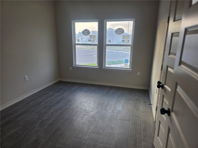 714 Mereet Dr, Corpus Christi, TX 78418 - spare room featuring dark wood-style flooring, baseboards, and a healthy amount of sunlight
