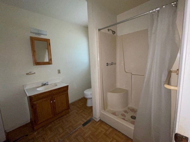 bathroom featuring vanity, parquet flooring, toilet, and a shower with curtain