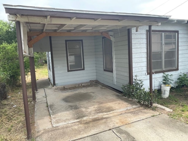 view of side of home with a carport