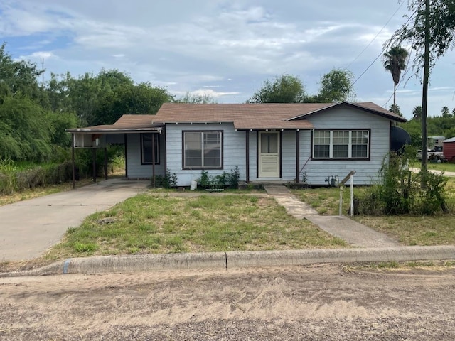 ranch-style house with a carport and a front yard