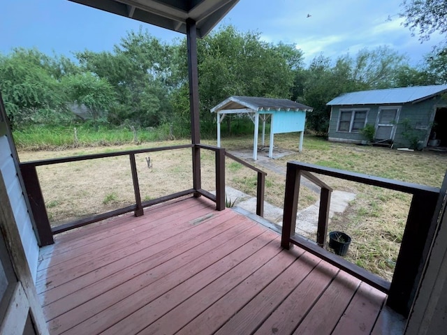 wooden terrace with a lawn and a storage shed