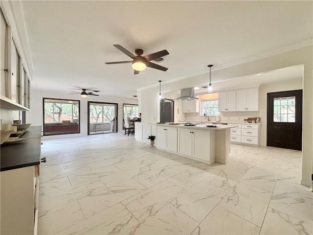 2551 Henrietta Pl, Ingleside, TX 78362 - kitchen with range hood, light marble finish flooring, white cabinetry, open floor plan, and ceiling fan