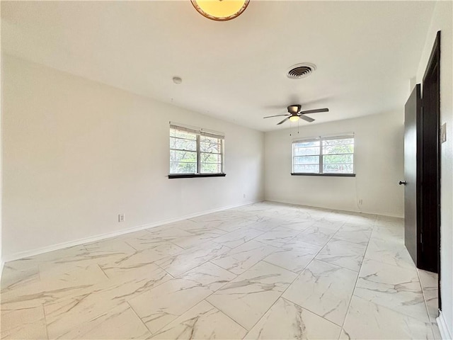 unfurnished room featuring visible vents, marble finish floor, ceiling fan, and baseboards