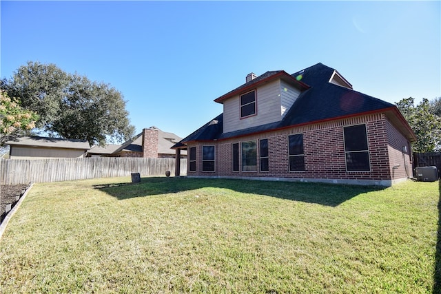 back of house featuring a yard