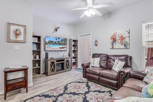 living room featuring a ceiling fan and wood finished floors