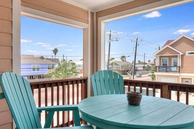 exterior space featuring outdoor dining space and a residential view