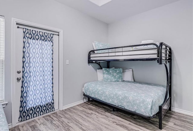 bedroom featuring baseboards and wood finished floors