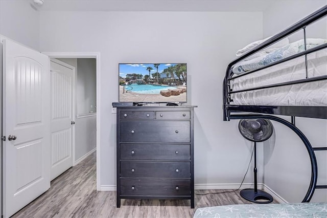 bedroom featuring baseboards and wood finished floors