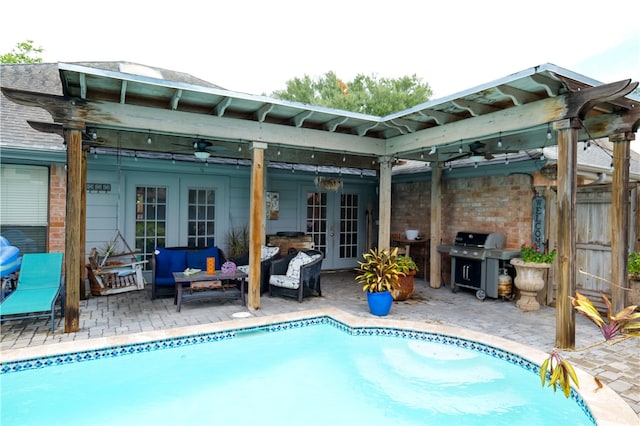 view of swimming pool featuring ceiling fan, a patio, french doors, and grilling area