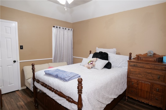 bedroom with dark hardwood / wood-style floors