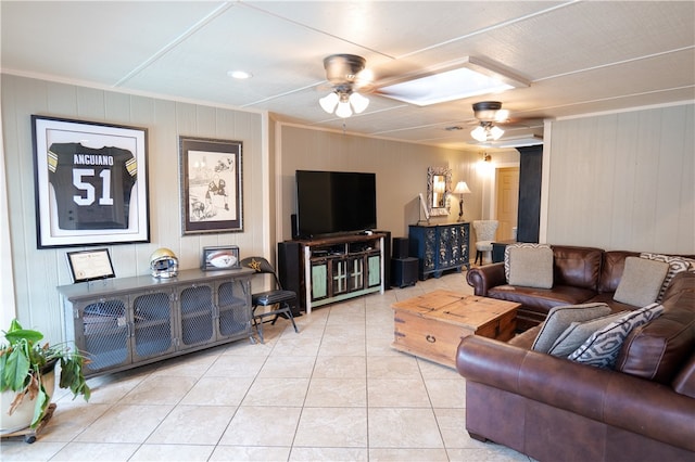 living room featuring wood walls, light tile patterned flooring, and ceiling fan