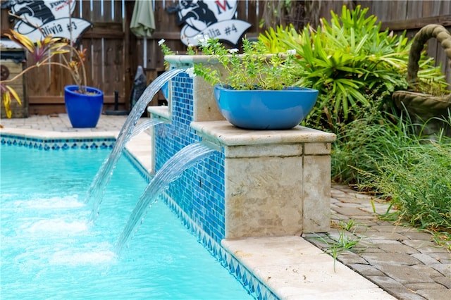 view of swimming pool featuring pool water feature