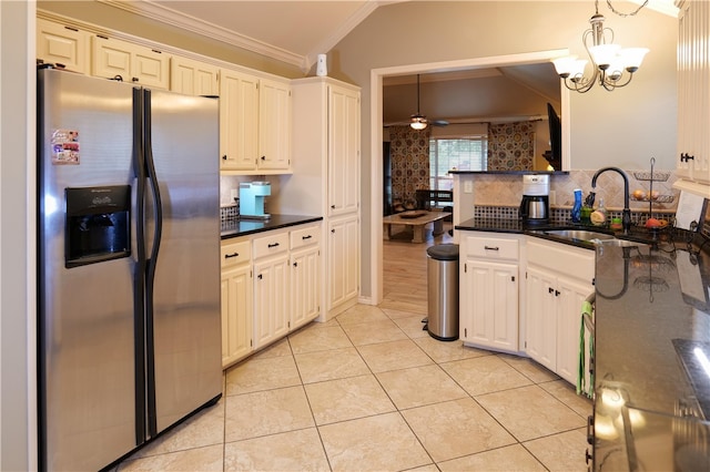 kitchen featuring stainless steel fridge with ice dispenser, sink, pendant lighting, and lofted ceiling