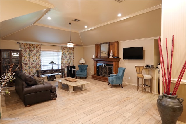 living room featuring ceiling fan, a raised ceiling, light hardwood / wood-style flooring, and crown molding