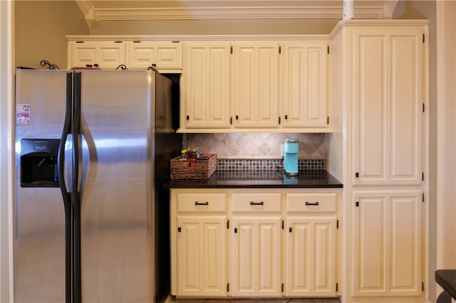 kitchen with tasteful backsplash, white cabinetry, stainless steel refrigerator with ice dispenser, and crown molding