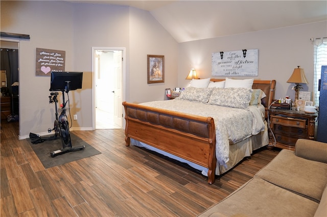 bedroom featuring dark hardwood / wood-style flooring and vaulted ceiling