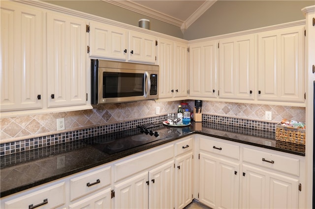 kitchen featuring black stovetop, white cabinetry, and crown molding