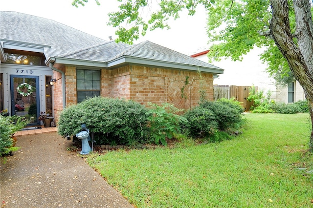 view of side of home featuring a lawn