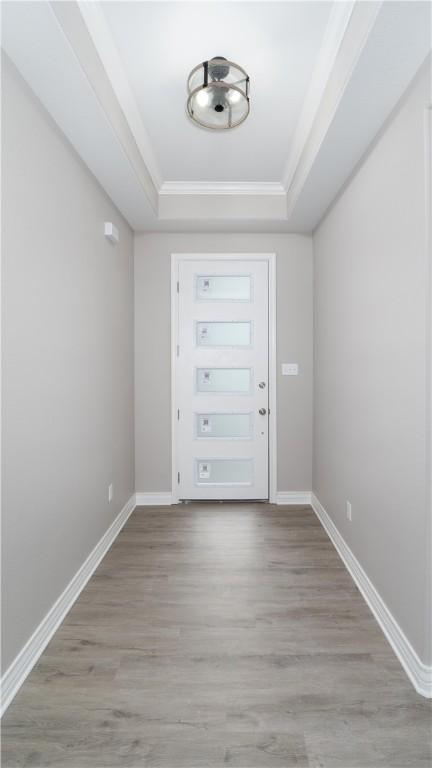 3634 Rebecca Dr, Corpus Christi, TX 78410 - entryway featuring a raised ceiling, wood finished floors, ornamental molding, and baseboards