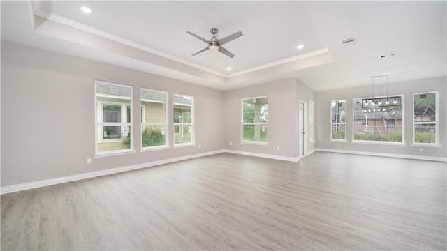 3634 Rebecca Dr, Corpus Christi, TX 78410 - unfurnished living room with a raised ceiling, wood finished floors, ornamental molding, a ceiling fan, and recessed lighting