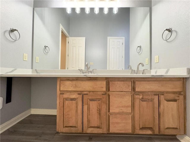 bathroom with hardwood / wood-style floors and vanity