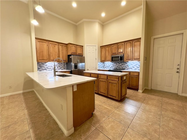 kitchen with sink, light tile patterned floors, ornamental molding, kitchen peninsula, and stainless steel appliances